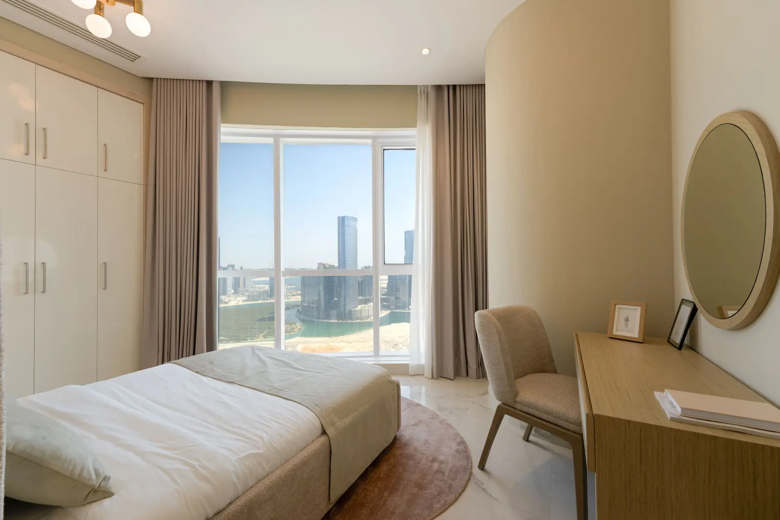 Spacious guest bedroom at Leaf Tower with comfortable contemporary design.